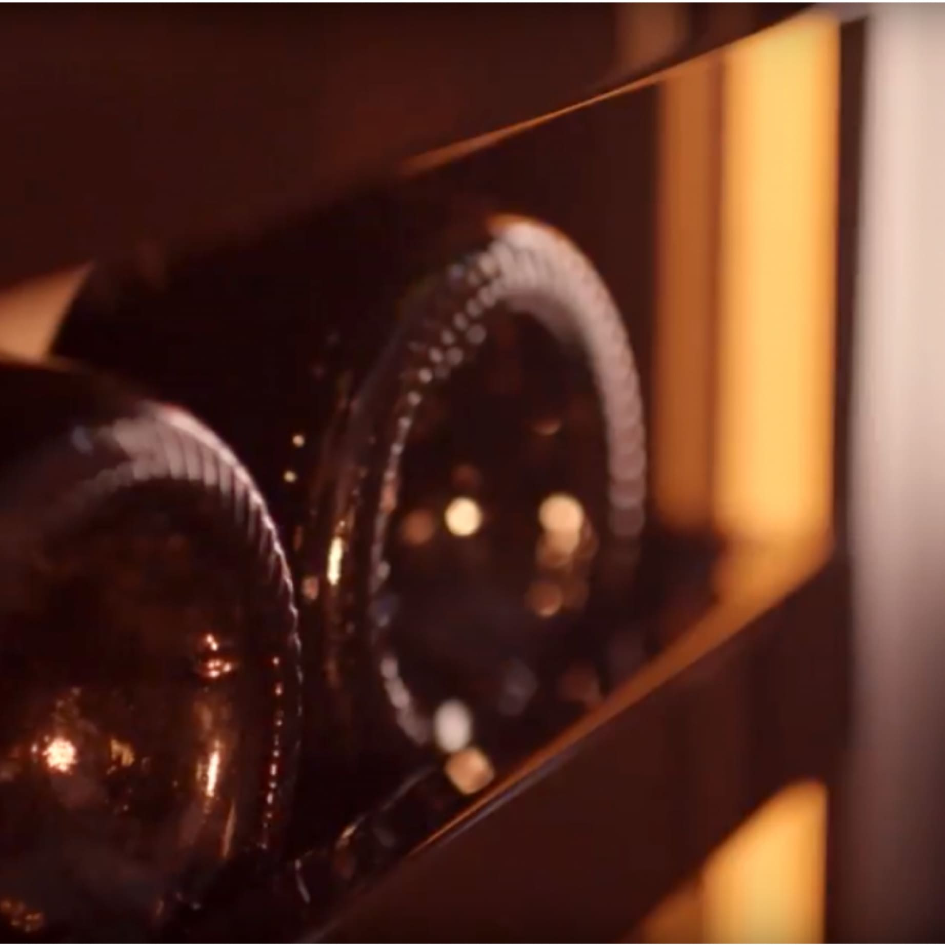 Éclairage des bouteilles dans toute l'armoire à vin créant un halo lumineux qui enveloppe doucement vos crus.