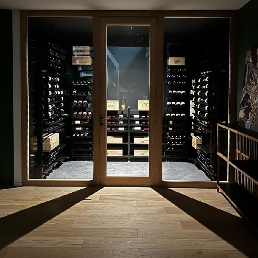 Projet d’aménagement d’une pièce cave à vin climatisée avec parois vitrée et l’installation d’étagères métalliques style industriel haut de gamme Modulo-X – Projet showroom EuroCave Annecy.